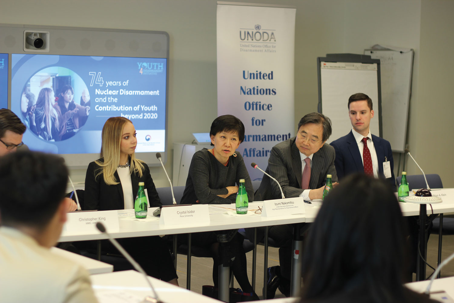 Izumi Nakamitsu speaking at microphone while seated with youth delegates and Permanent Representative Cho Hyun of the Republic of Korea